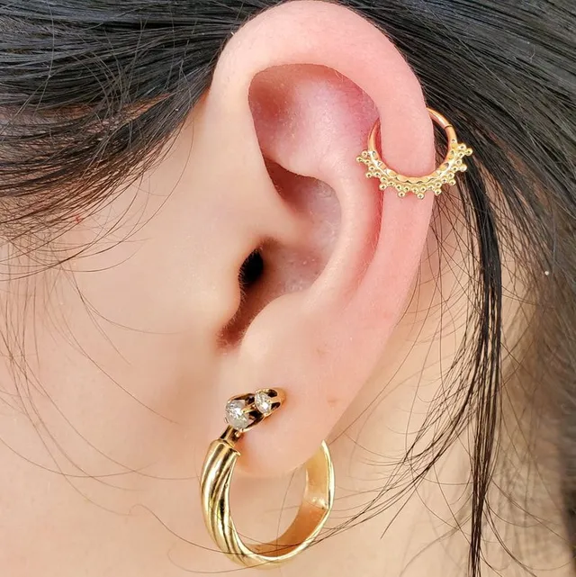 Gold ear jewelry piercing